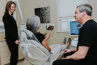 Photo of Dr. Welch and hygeinist working on patient